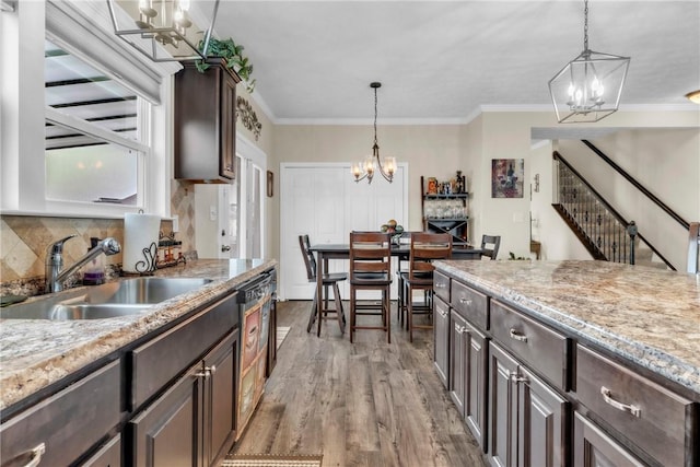 201 Millstream Ln, Zelienople Boro, PA 16063 - kitchen with a chandelier, dark brown cabinetry, wood finished floors, hanging light fixtures, and ornamental molding