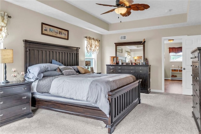 201 Millstream Ln, Zelienople Boro, PA 16063 - bedroom with light carpet, a tray ceiling, ensuite bath, and ceiling fan