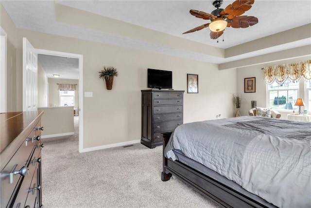 201 Millstream Ln, Zelienople Boro, PA 16063 - bedroom featuring light carpet, multiple windows, a tray ceiling, and ceiling fan