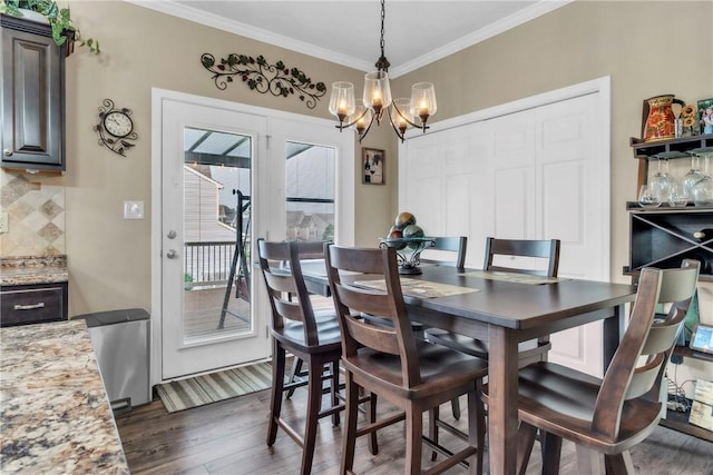 201 Millstream Ln, Zelienople Boro, PA 16063 - dining area with dark wood-style flooring, ornamental molding, and a chandelier