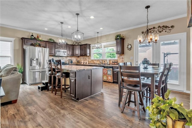 201 Millstream Ln, Zelienople Boro, PA 16063 - kitchen with stainless steel appliances, a chandelier, dark brown cabinetry, a kitchen island, and ornamental molding