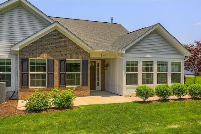 705 Spring Valley Dr, Jackson Twp, PA 16063 - view of front of property featuring brick siding, a shingled roof, and a front yard