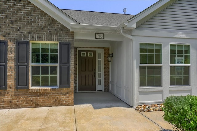 705 Spring Valley Dr, Jackson Twp, PA 16063 - view of exterior entry featuring brick siding and a shingled roof