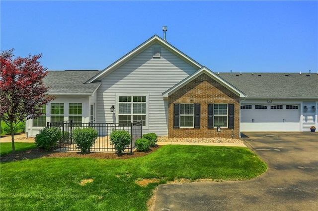 705 Spring Valley Dr, Jackson Twp, PA 16063 - view of front facade featuring brick siding, driveway, a front lawn, a shingled roof, and an attached garage