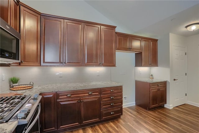 705 Spring Valley Dr, Jackson Twp, PA 16063 - kitchen with stainless steel appliances, light stone counters, dark wood-style flooring, and backsplash