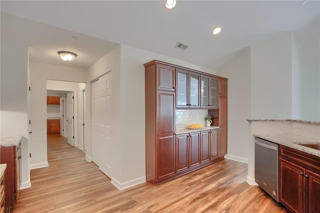 705 Spring Valley Dr, Jackson Twp, PA 16063 - kitchen featuring dishwasher, light wood-style floors, backsplash, light stone countertops, and glass insert cabinets