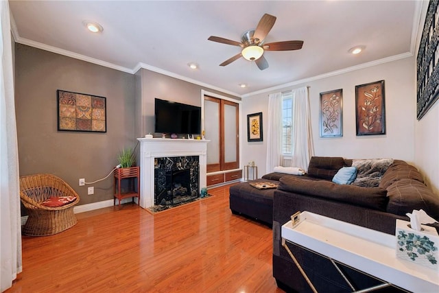 323 Fairmont St, Latrobe, PA 15650 - living room with light wood-style floors, a ceiling fan, ornamental molding, a premium fireplace, and recessed lighting