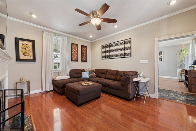 323 Fairmont St, Latrobe, PA 15650 - living room with wood finished floors, a ceiling fan, ornamental molding, a fireplace, and recessed lighting