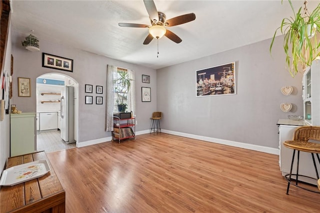 323 Fairmont St, Latrobe, PA 15650 - living area with arched walkways, ceiling fan, and wood finished floors