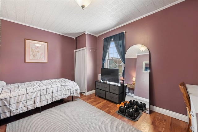 323 Fairmont St, Latrobe, PA 15650 - bedroom with wood finished floors, crown molding, and arched walkways