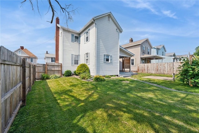 323 Fairmont St, Latrobe, PA 15650 - rear view of house with a fenced backyard and a chimney