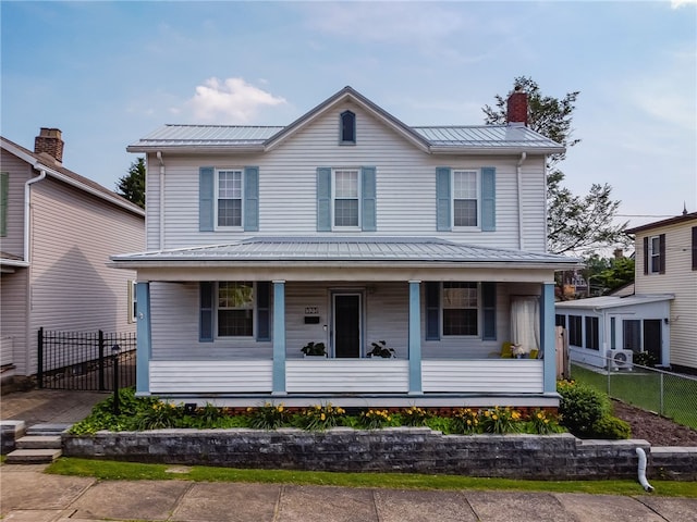 323 Fairmont St, Latrobe, PA 15650 - view of front facade featuring a porch, a metal roof, and a chimney