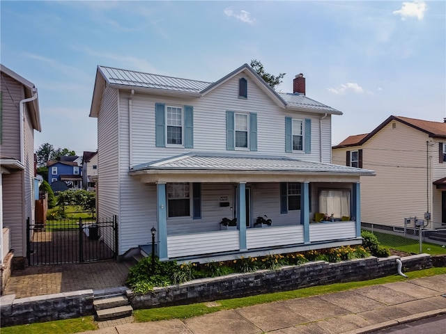 323 Fairmont St, Latrobe, PA 15650 - view of front facade featuring a standing seam roof, a metal roof, a porch, a chimney, and a gate