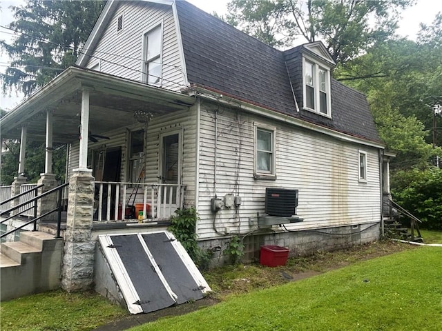 108 Leneake St, Wilkins Twp, PA 15145 - view of home's exterior featuring covered porch, roof with shingles, a yard, and a gambrel roof