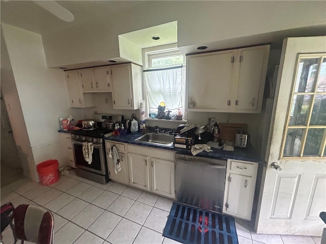 108 Leneake St, Wilkins Twp, PA 15145 - kitchen featuring appliances with stainless steel finishes, dark countertops, light tile patterned floors, and white cabinets