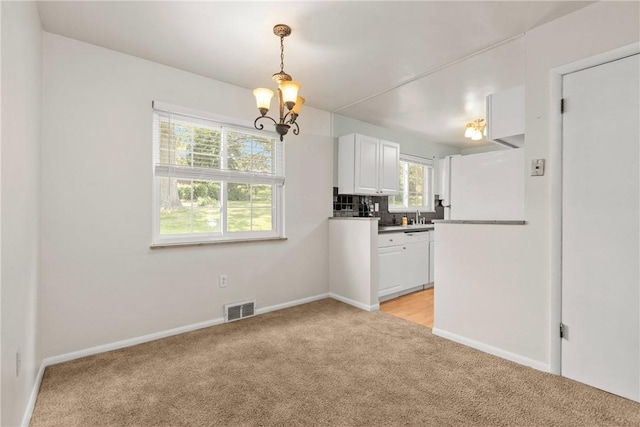 5311 Clearview Ave, Hopewell Twp Bea, PA 15001 - kitchen featuring light carpet, white appliances, a chandelier, white cabinets, and decorative backsplash