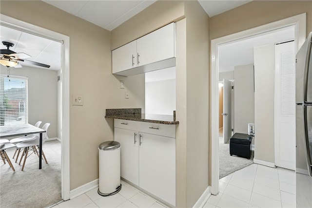 5 Bayard Rd Unit 113, Shadyside, PA 15213 - kitchen with ceiling fan, light carpet, white cabinets, freestanding refrigerator, and light tile patterned floors