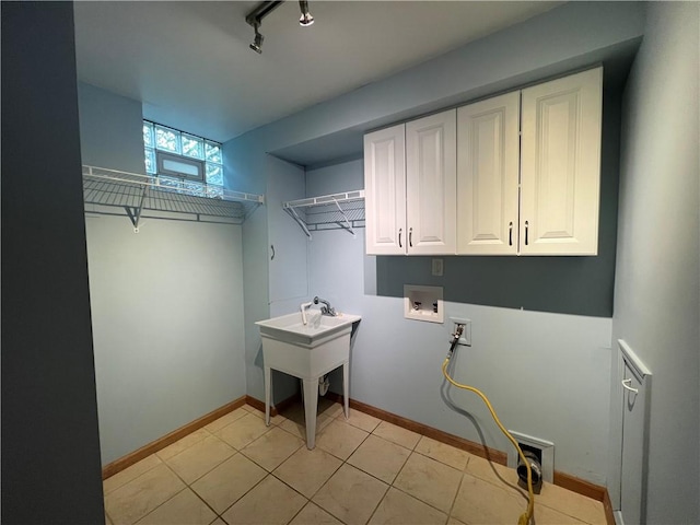 742 King St, Mckeesport, PA 15132 - washroom featuring washer hookup, cabinet space, and light tile patterned floors