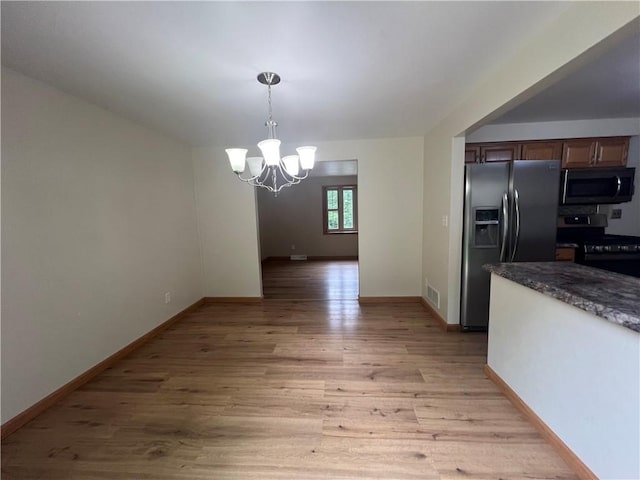 742 King St, Mckeesport, PA 15132 - unfurnished dining area featuring a chandelier and light wood-style flooring