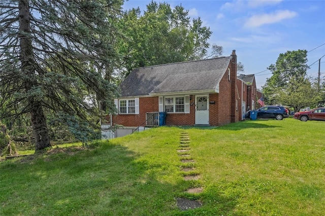 301 Pennview Dr, Penn Hills, PA 15235 - view of front of home with brick siding, a front yard, and a chimney