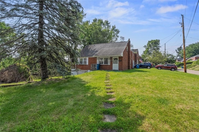 301 Pennview Dr, Penn Hills, PA 15235 - view of front facade with brick siding, a front lawn, and a chimney