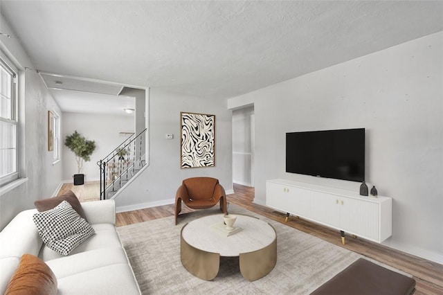 301 Pennview Dr, Penn Hills, PA 15235 - living area with wood finished floors, a textured ceiling, and stairway