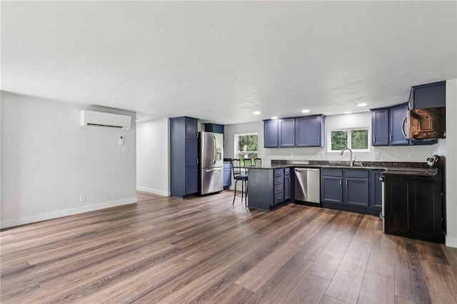 105 Becks Run Rd, Moon/Crescent Twp, PA 15108 - kitchen with stainless steel appliances, a wall mounted AC, dark countertops, dark wood-style flooring, and a breakfast bar