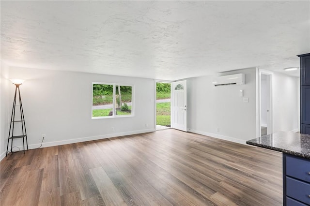 105 Becks Run Rd, Moon/Crescent Twp, PA 15108 - unfurnished living room with a wall unit AC and wood finished floors