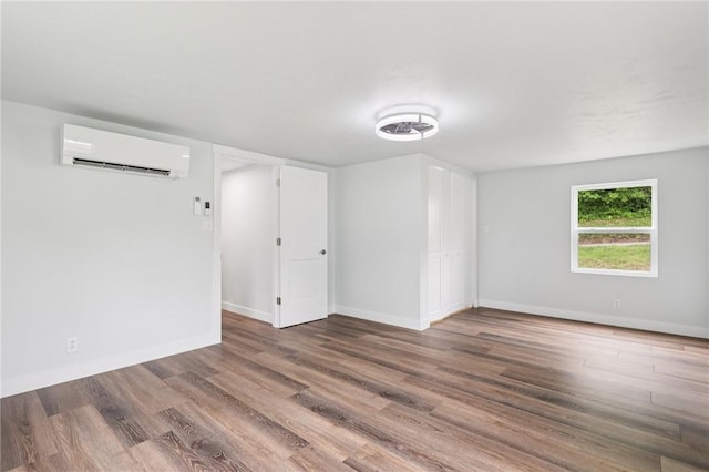 105 Becks Run Rd, Moon/Crescent Twp, PA 15108 - spare room with an AC wall unit and wood finished floors