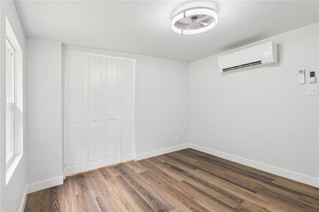 105 Becks Run Rd, Moon/Crescent Twp, PA 15108 - unfurnished bedroom featuring a wall unit AC, wood finished floors, and a closet