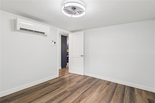 105 Becks Run Rd, Moon/Crescent Twp, PA 15108 - spare room with a wall unit AC and wood finished floors