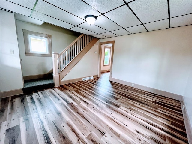 64 Beech St, Center Twp/Homer Cty, PA 15748 - unfurnished living room featuring a paneled ceiling, stairs, wood finished floors, and plenty of natural light
