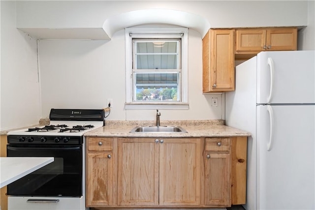 3937 Davis Ave, Munhall, PA 15120 - kitchen with freestanding refrigerator, gas range oven, and light brown cabinets