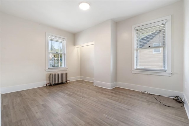 3937 Davis Ave, Munhall, PA 15120 - unfurnished room featuring radiator, light wood-style floors, and healthy amount of natural light