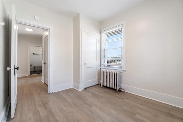3937 Davis Ave, Munhall, PA 15120 - unfurnished bedroom featuring radiator heating unit and light wood-style flooring