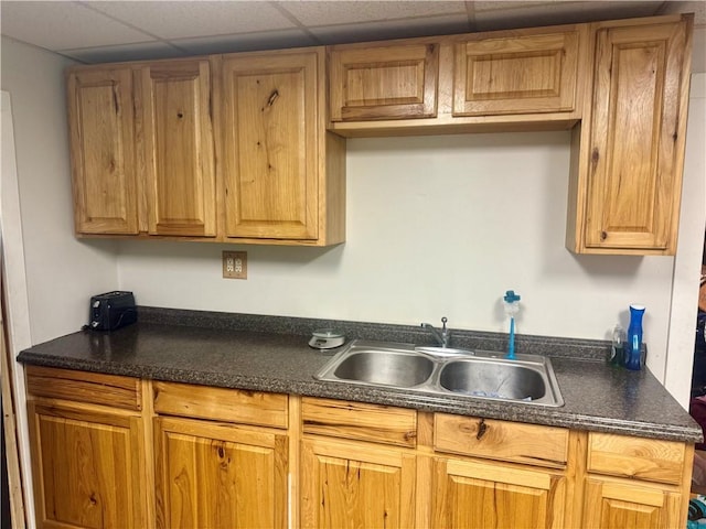 108 13th Ave, City Of But Nw, PA 16001 - kitchen featuring dark countertops, brown cabinets, and a drop ceiling