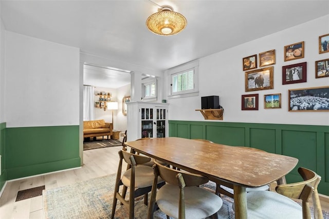 430 Lamar Ave, Regent Square, PA 15221 - dining area with ornate columns, wood finished floors, a wainscoted wall, and a decorative wall
