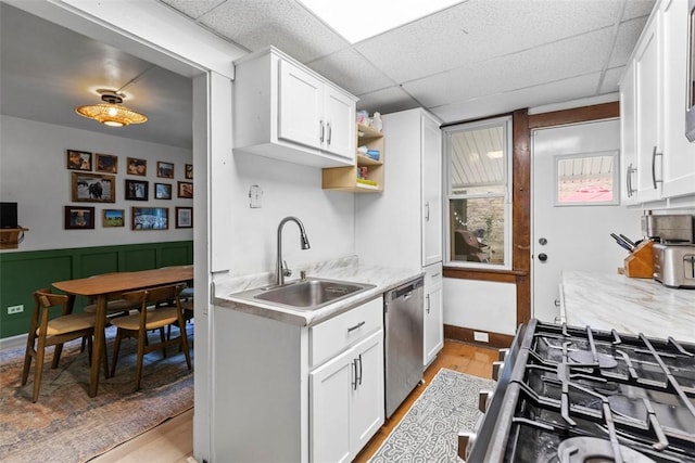 430 Lamar Ave, Regent Square, PA 15221 - kitchen with dishwasher, light countertops, white cabinetry, light wood-type flooring, and a paneled ceiling