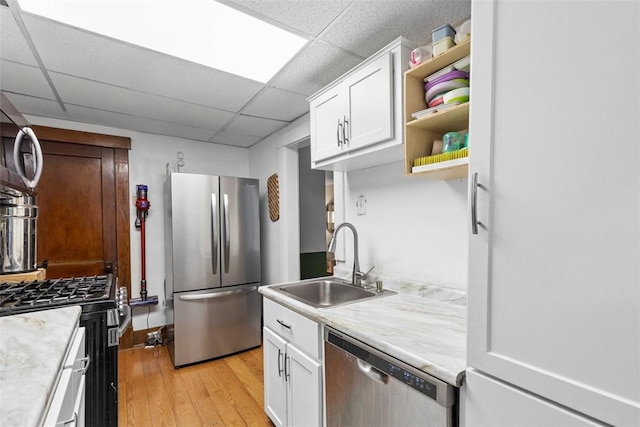 430 Lamar Ave, Regent Square, PA 15221 - kitchen featuring appliances with stainless steel finishes, light wood-style flooring, light countertops, open shelves, and a drop ceiling