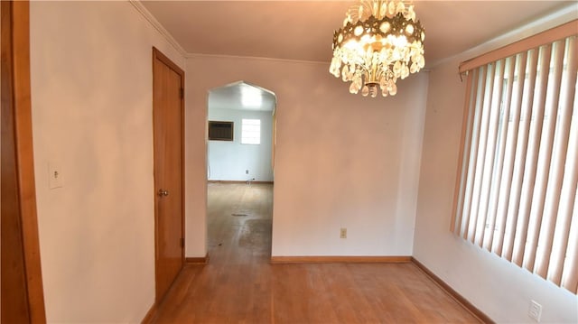 3550 Camp St, Hill District, PA 15219 - unfurnished dining area featuring arched walkways, wood finished floors, ornamental molding, and a chandelier