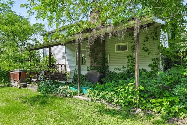 27 Windridge Dr, North Union Twp, PA 15401 - rear view of house with a chimney and a yard