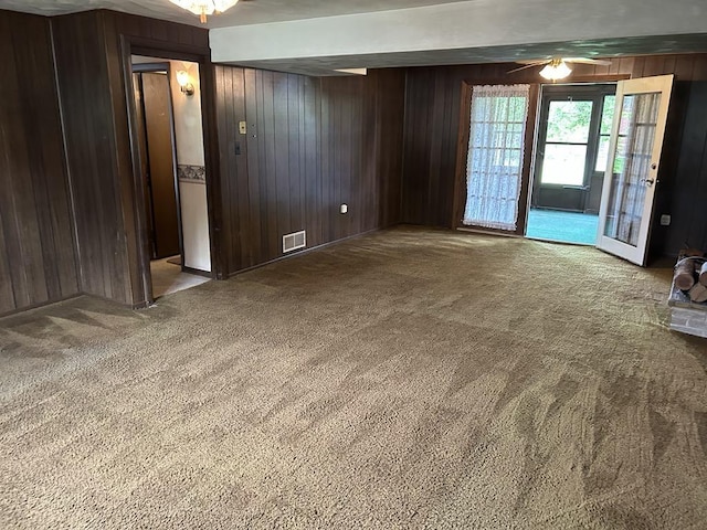 307 Debora Dr, Latrobe, PA 15650 - empty room featuring wooden walls, carpet, and ceiling fan
