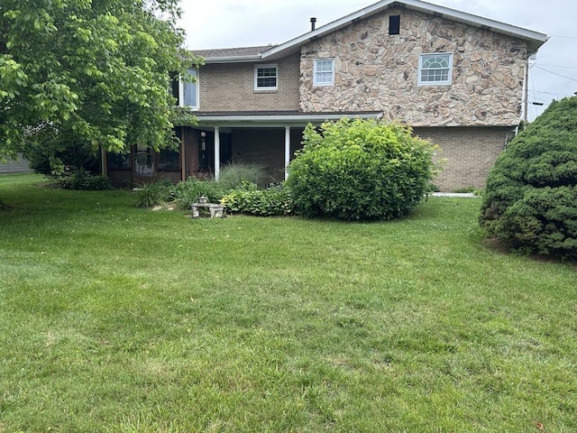 307 Debora Dr, Latrobe, PA 15650 - rear view of house with a yard, brick siding, and stone siding
