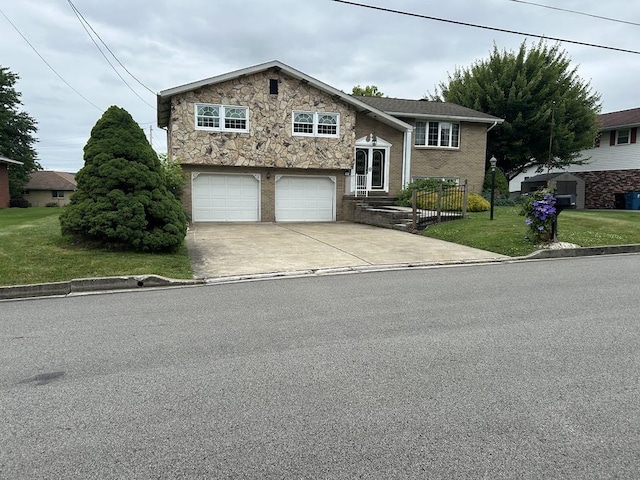 307 Debora Dr, Latrobe, PA 15650 - raised ranch featuring concrete driveway, a front lawn, a garage, and stone siding