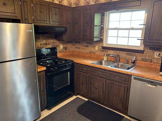 307 Debora Dr, Latrobe, PA 15650 - kitchen with stainless steel appliances, range hood, backsplash, and dark brown cabinetry