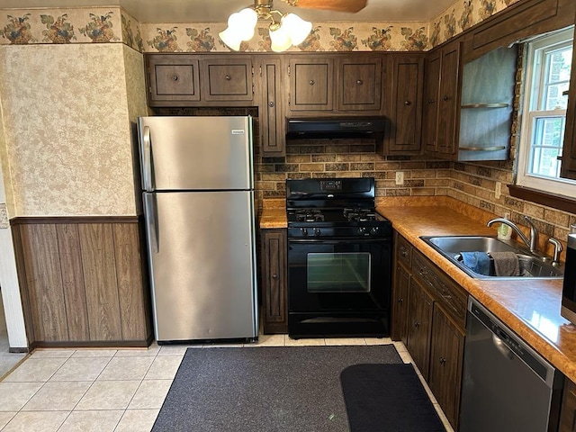 307 Debora Dr, Latrobe, PA 15650 - kitchen featuring appliances with stainless steel finishes, ventilation hood, light tile patterned flooring, dark brown cabinetry, and decorative backsplash