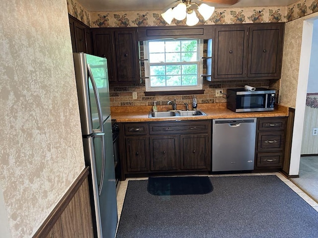 307 Debora Dr, Latrobe, PA 15650 - kitchen featuring appliances with stainless steel finishes, dark brown cabinetry, light countertops, ceiling fan, and decorative backsplash