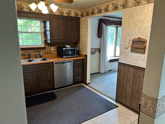 307 Debora Dr, Latrobe, PA 15650 - kitchen featuring dishwasher, wallpapered walls, dark brown cabinetry, ceiling fan, and light countertops