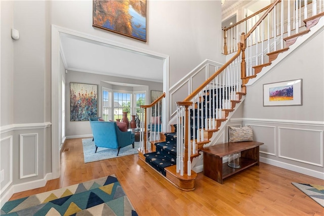 1002 Sunset Way, Menallen Twp, PA 15401 - stairway with wood finished floors, crown molding, and a decorative wall