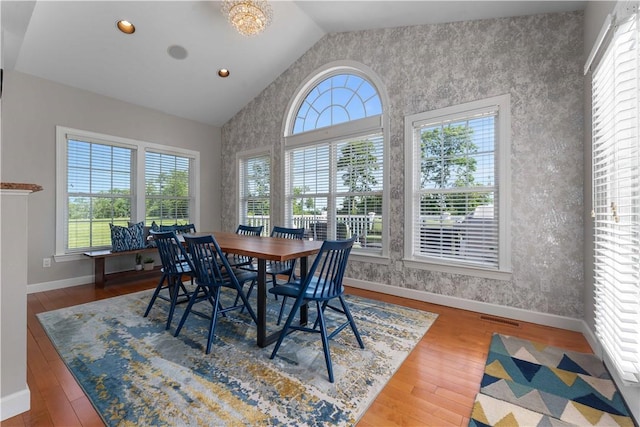 1002 Sunset Way, Menallen Twp, PA 15401 - dining space with lofted ceiling, wallpapered walls, wood finished floors, recessed lighting, and an accent wall